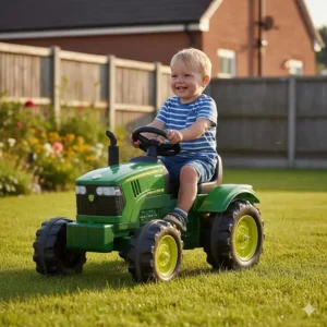 A sturdy green toy tractor ride-on with chunky wheels driving over short garden grass.