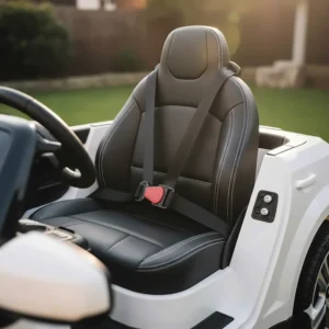 Interior view of a BMW ride-on car highlighting the adjustable safety seatbelt and padded faux-leather seat.
