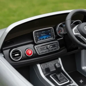 The realistic dashboard of a kids' Mercedes car including a functional MP3 player and horn.