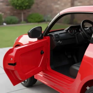 Close-up view of a red toddler ride on car with opening doors showing the internal safety latch.