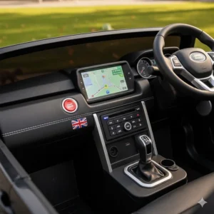 The interior dashboard of a kids motorised vehicle featuring an MP3 player, start button, and realistic steering wheel.