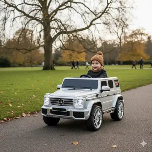 A toddler enjoying a luxury ride on SUV on a paved path in a British public park.