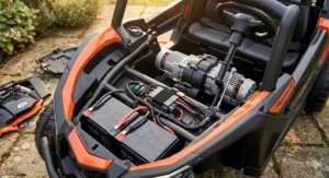 Under-seat view showing the 24V rechargeable battery and powerful motor components of the electric Can-Am Maverick ride-on.