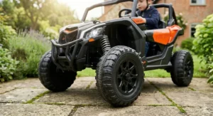 Detailed view of the heavy-duty off-road tyres and front spring suspension on a kids' electric Can-Am Maverick ride-on.