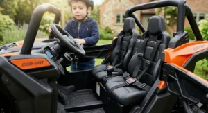 The interior of the Can-Am Maverick ride-on showing two padded seats equipped with adjustable safety lap belts for children.