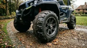 Durable EVA rubber tyres on a kids' 24v buggy, designed for gravel paths and damp UK terrain.