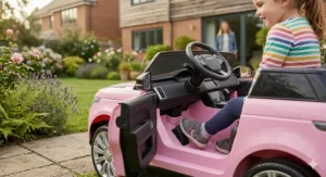 Close-up of a secure safety harness and a parent using a remote control for a girls' ride-on car.