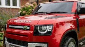 Close-up of the official Land Rover bonnet badge and silver grille on a premium licensed ride-on car for kids.