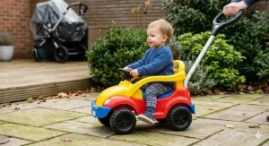 Colourful toddler push-along car with a parent handle, ideal as a first ride-on car Christmas gift.
