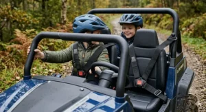 Inside the cockpit of a two-seater electric buggy showing side-by-side seating for two children.