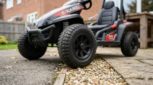 Low-angle shot of the heavy-duty rubber tyres on a 24v electric go kart, shown on a typical UK paved driveway and gravel.