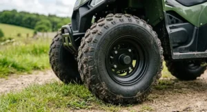 Detailed view of the deep-tread knobbly tyres on an all terrain quad for kids, designed for muddy British terrain.