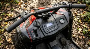 Top-down view of the 12v off road quad handlebars and gear stick, showing the forward and reverse controls and the textured foot pedal.
