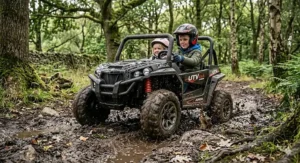 A child steering a black 4x4 UTV through a woodland trail, demonstrating its off-road capabilities on uneven terrain.