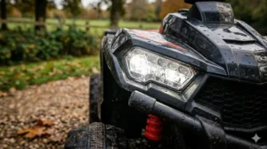 Close-up view of the working LED front lights on a child’s quad bike, showing the bright illumination.