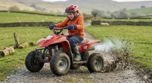 A children’s petrol quad bike demonstrating power and torque while driving through muddy off-road terrain in the UK.