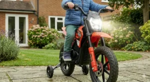The front view of a miniature electric motorcycle featuring functional LED headlights for realistic play.