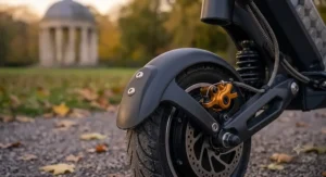 Close-up of the robust mudguards fitted to the rear wheel of a kids' electric scooter.