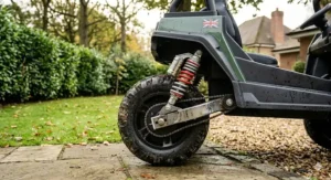 Side profile of kids' off-road quad bike showing spring suspension system for uneven ground.