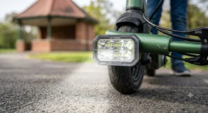 Bright front LED headlight on an electric scooter providing improved visibility for young riders.