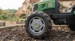 View of the comfortable, adjustable black plastic seat on the large green ride-on tractor.