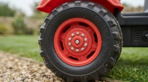 Side view showing the heavy-duty, rugged wheels designed for outdoor terrain on the tractor.
