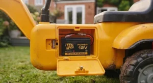 Four-year-old child easily reaching the steering wheel of a standard JCB ride-on digger