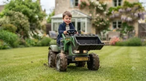 A child driving their 24v electric tractor across a garden lawn.