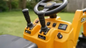 Close-up of the steering wheel and functional bucket levers on a child's electric ride-on JCB digger.