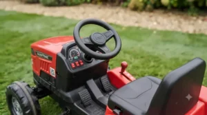 Detailed view of the adjustable seat on the ride-on tractor to suit growing children.