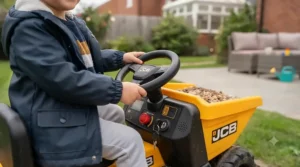 Close-up of the steering wheel and dashboard features on an official JCB ride-on dumper, highlighting child-friendly controls.