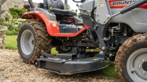 A wide mid-mount mower deck attached to a ride-on tractor for efficient grass cutting.