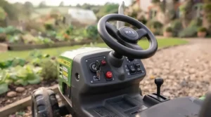 Detailed view of the large, rugged rear driving wheel and deep-tread tyre of the ride-on tractor.