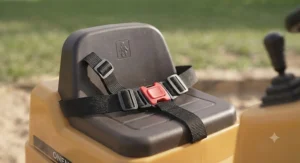 Young child wearing a safety helmet while safely seated on a ride-on excavator toy
