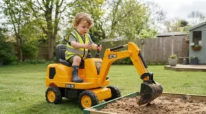 Toddler having fun scooping soil with a battery-powered excavator toy outdoors in a garden.