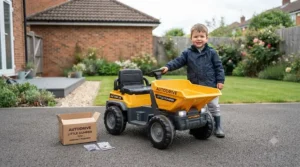 Fully assembled electric ride-on dumper truck ready for play parked on a clean tarmac driveway.
