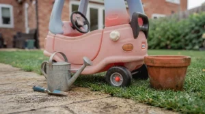 Size comparison illustration showing the compact proportions of the pink ride-on car suited for British gardens and hallways.