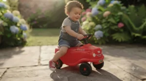 Young child demonstrating foot-to-floor movement on a push-along first ride-on car for toddlers.
