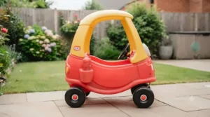 Side profile of the classic red Little Tikes Cozy Coupe illustrating overall proportions and ride-on height for young children.