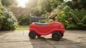 Child playing outside on the patio with their outdoor-friendly first ride-on car for toddlers.