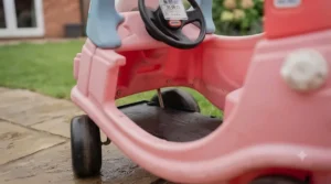 Interior view showing the removable floor board of the Cozy Coupe for parent-controlled pushes or toddler foot-to-floor motion.