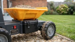 Rechargeable 12v battery port and power switch on the side of a children's electric ride-on dumper truck.