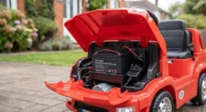 Charging port and rechargeable battery setup on a blue battery-powered truck ride-on toy