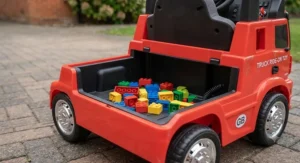 Open storage boot at the back of a kids ride-on toy truck filled with plastic play bricks