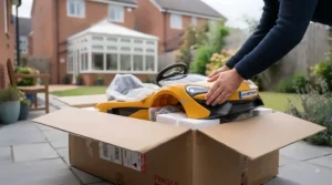 A parent assembling a brand new luxury sports car ride-on toy out of its delivery box.