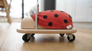 Side profile of the Wheelybug ladybird highlighting its low centre of gravity ideal for early walkers.