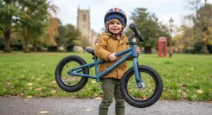 Side profile of a blue metal balance bike featuring a low step-through frame for younger toddlers.