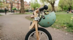 Pneumatic rubber tyres on a wooden balance bike ready for pavement and park terrain.