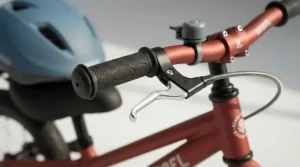 Close-up of safe, anti-slip handlebar grips on a sturdy steel toddler balance bike.